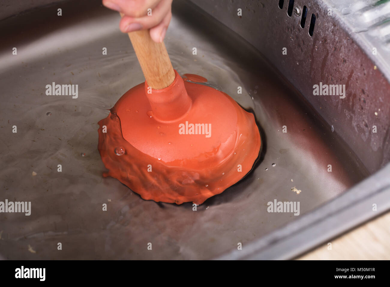 Premium Photo  Kitchen sink full of dirty water red plunger