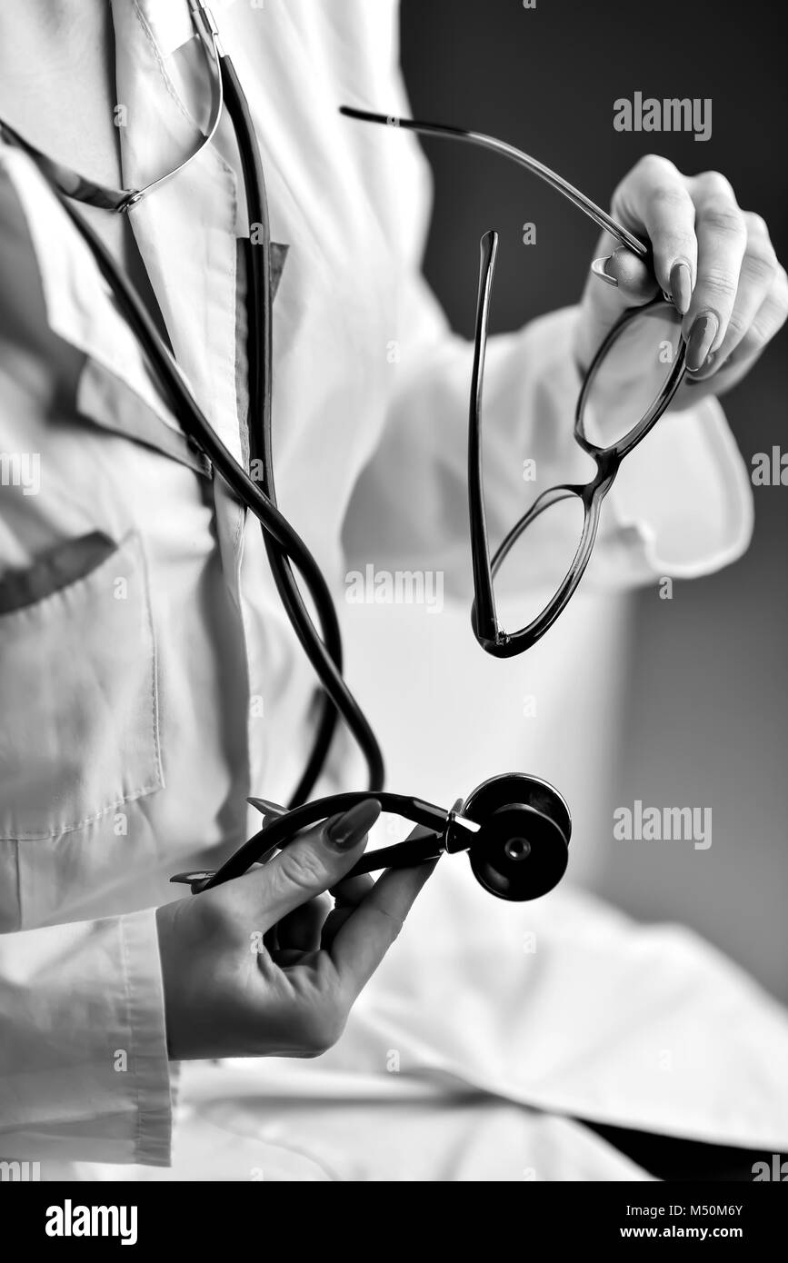 Black doctor hands stethoscope Black and White Stock Photos & Images ...