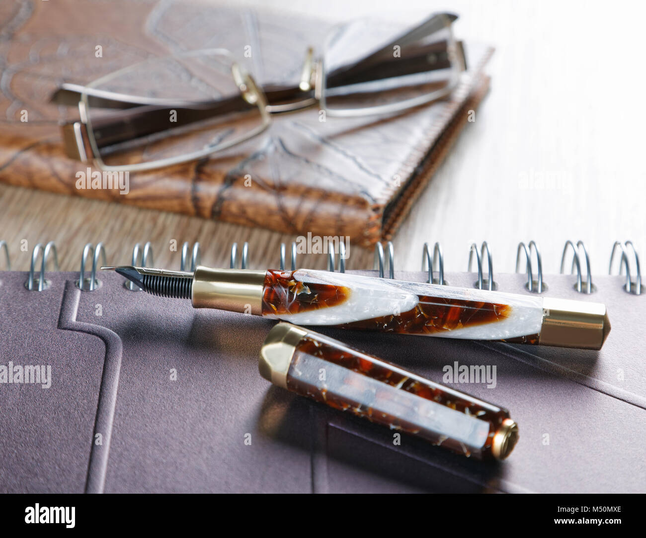 fountain pens and diaries with leather cover Stock Photo