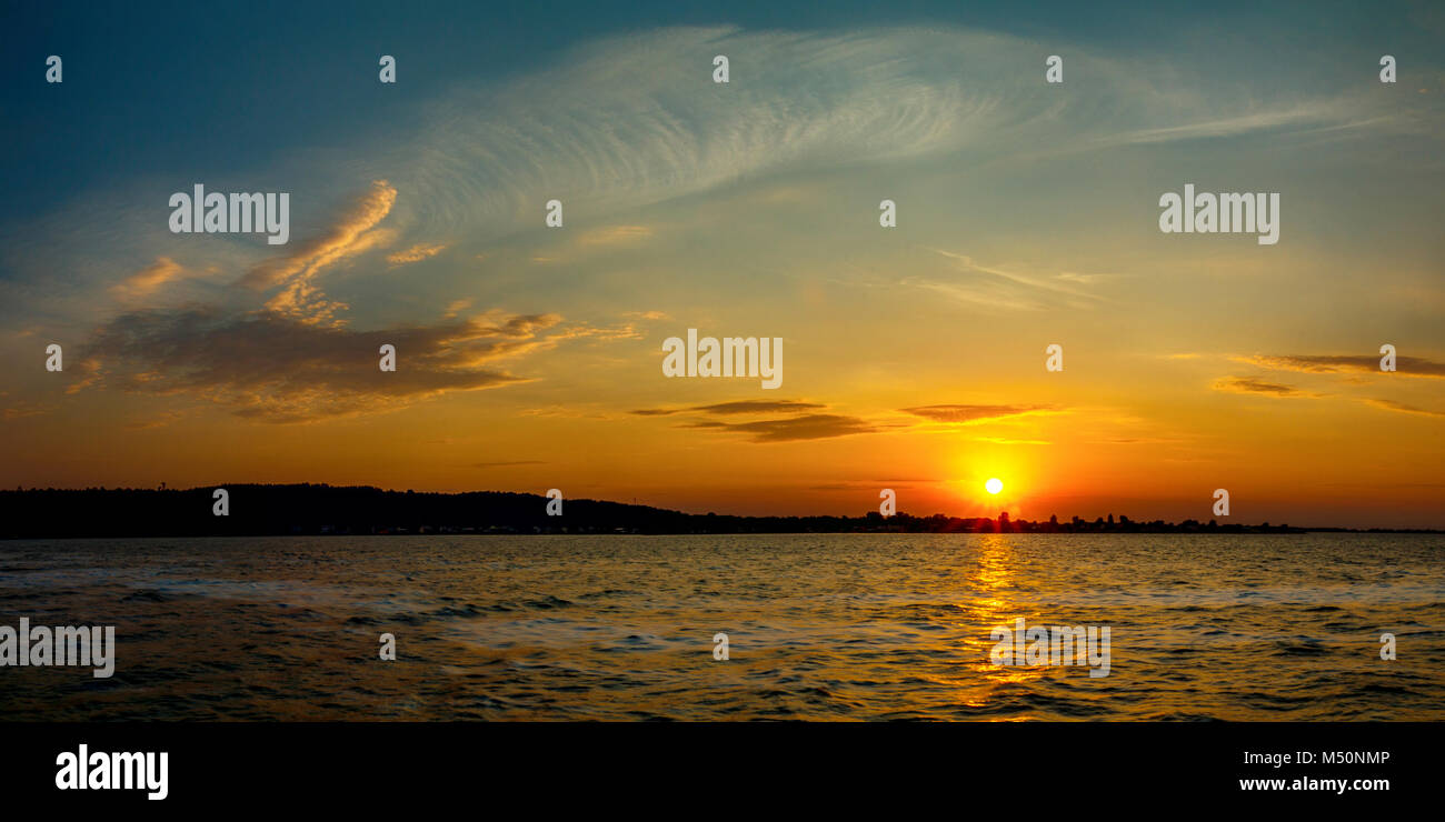 Stunning sunset colors with the cloudy sky Stock Photo - Alamy
