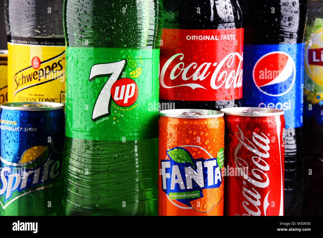 Bottles and cans of assorted global soft drinks Stock Photo Alamy