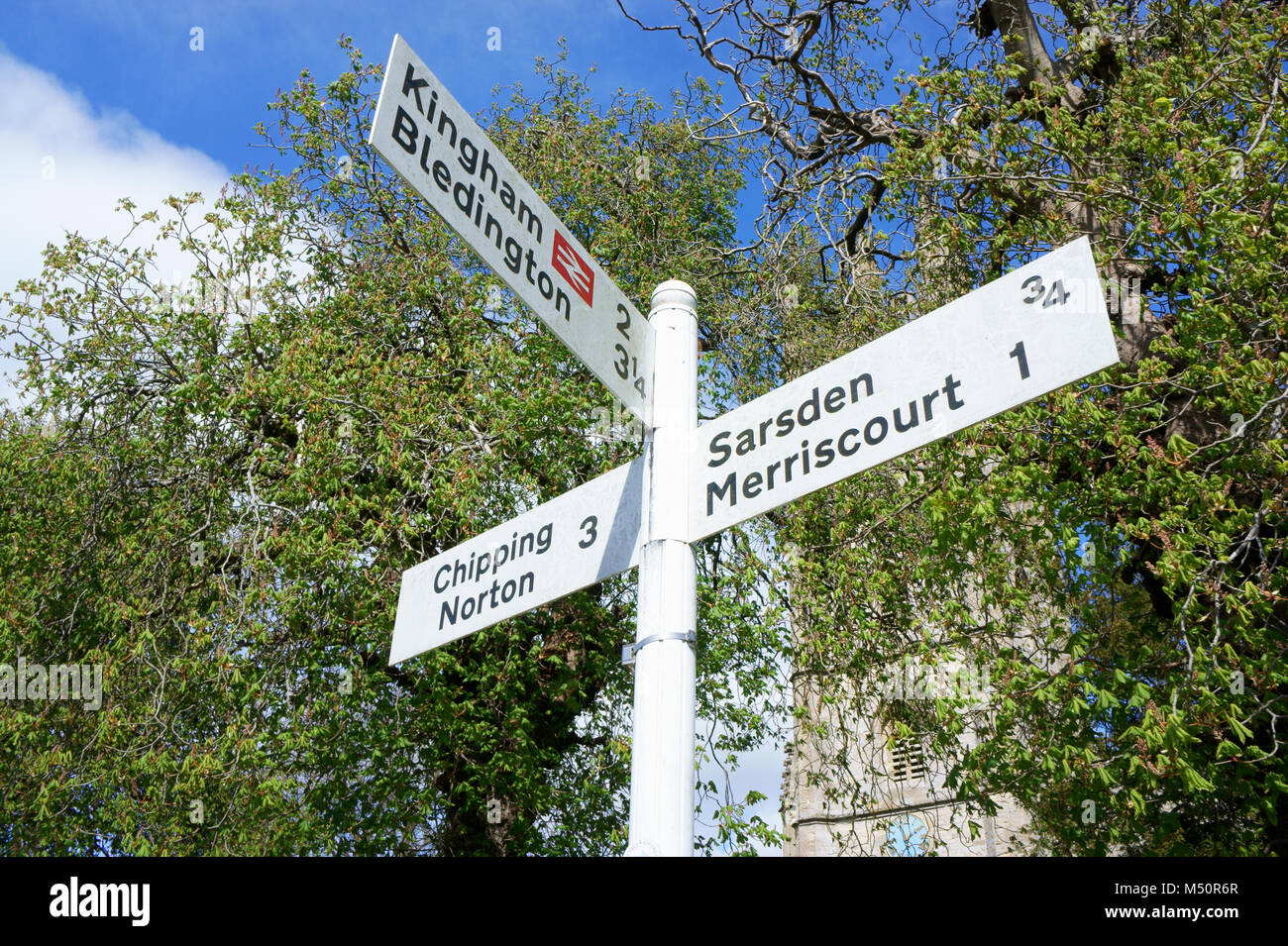 Village Signpost in Churchill, Oxfordshire, England, UK. Stock Photo
