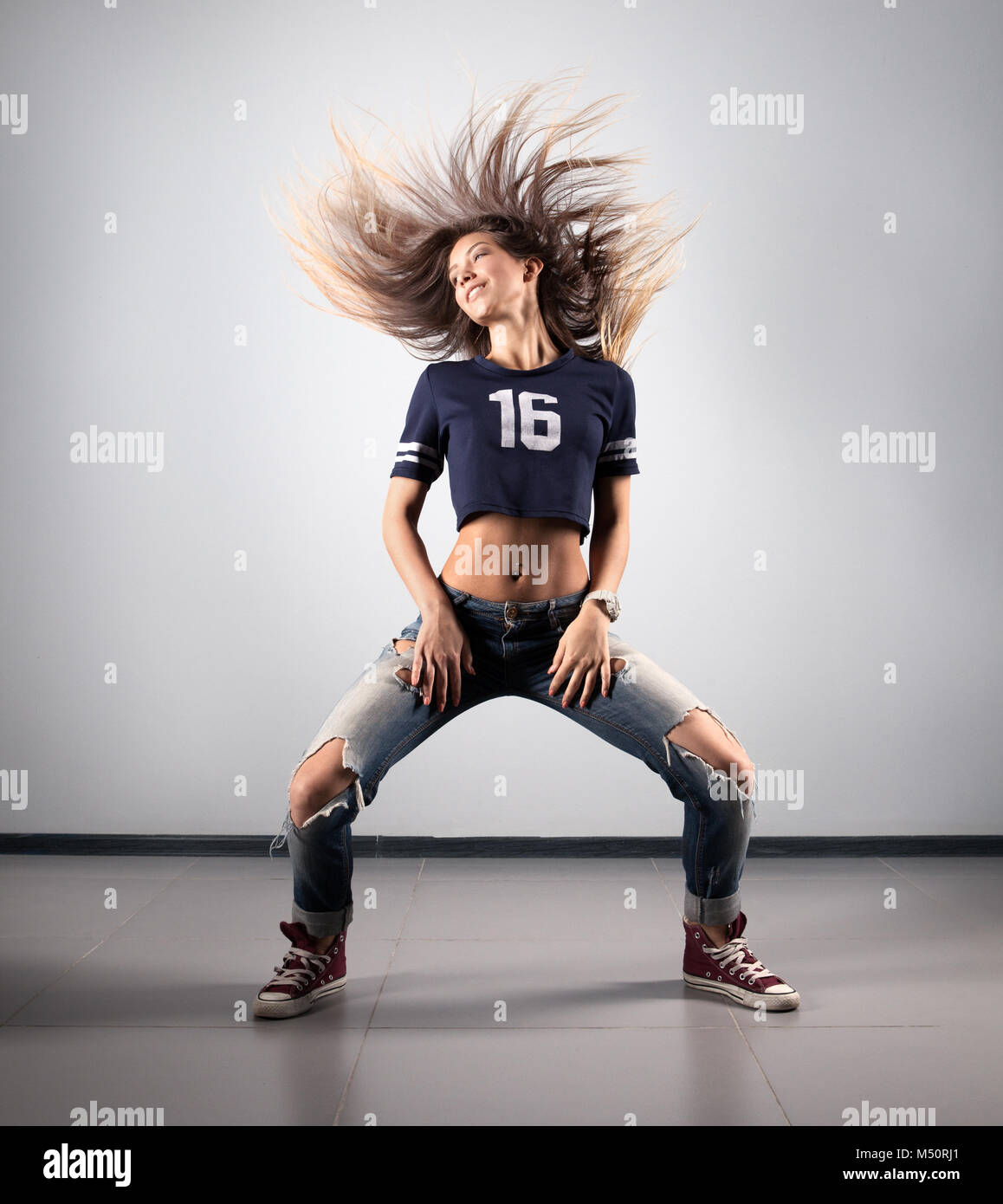 modern young beautiful dancer posing on a studio background Stock Photo