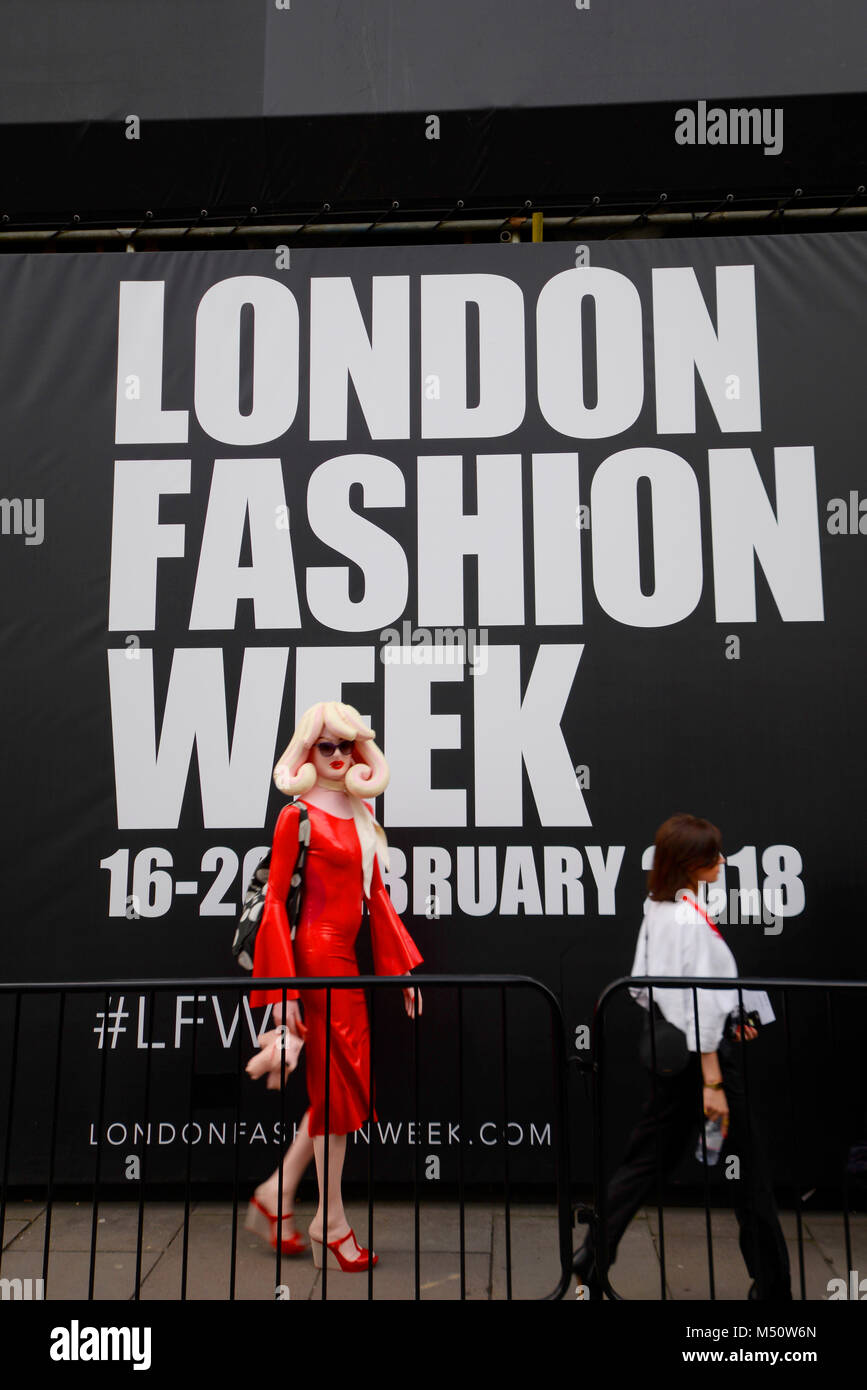Plastic doll like female person at London Fashion Week February 2018 with logo, brand lettering and date Stock Photo