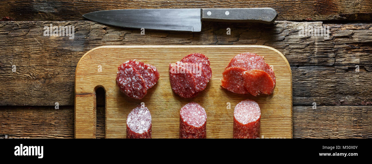 Wooden cutting board with salami Stock Photo Alamy
