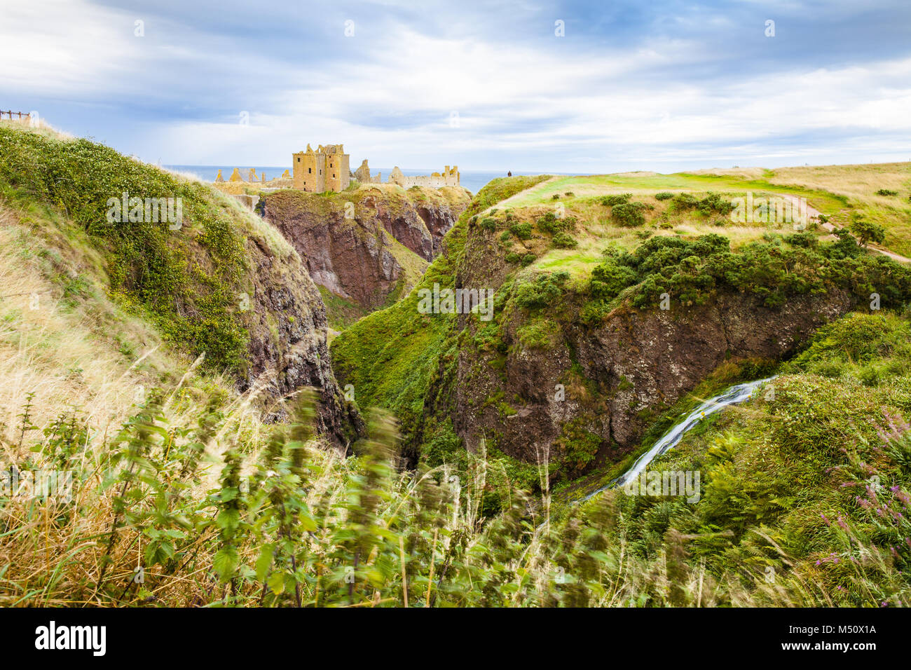 dunnottar castle and hits landscape at sunset scotland united kingdom Stock Photo