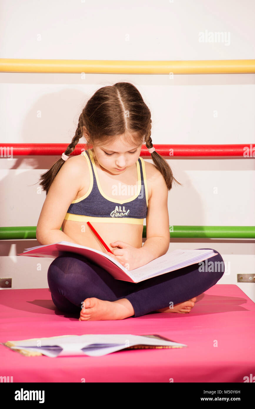 Little caucasian 6 8 years old girl doing one s lessons at the gym