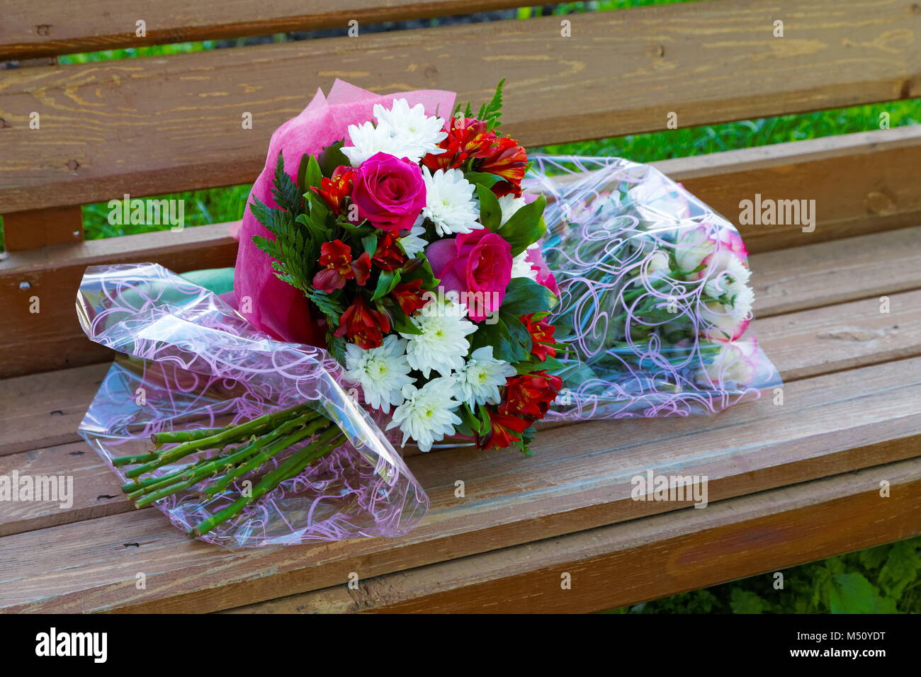 Two bouquets of roses on a bench in the summer Stock Photo