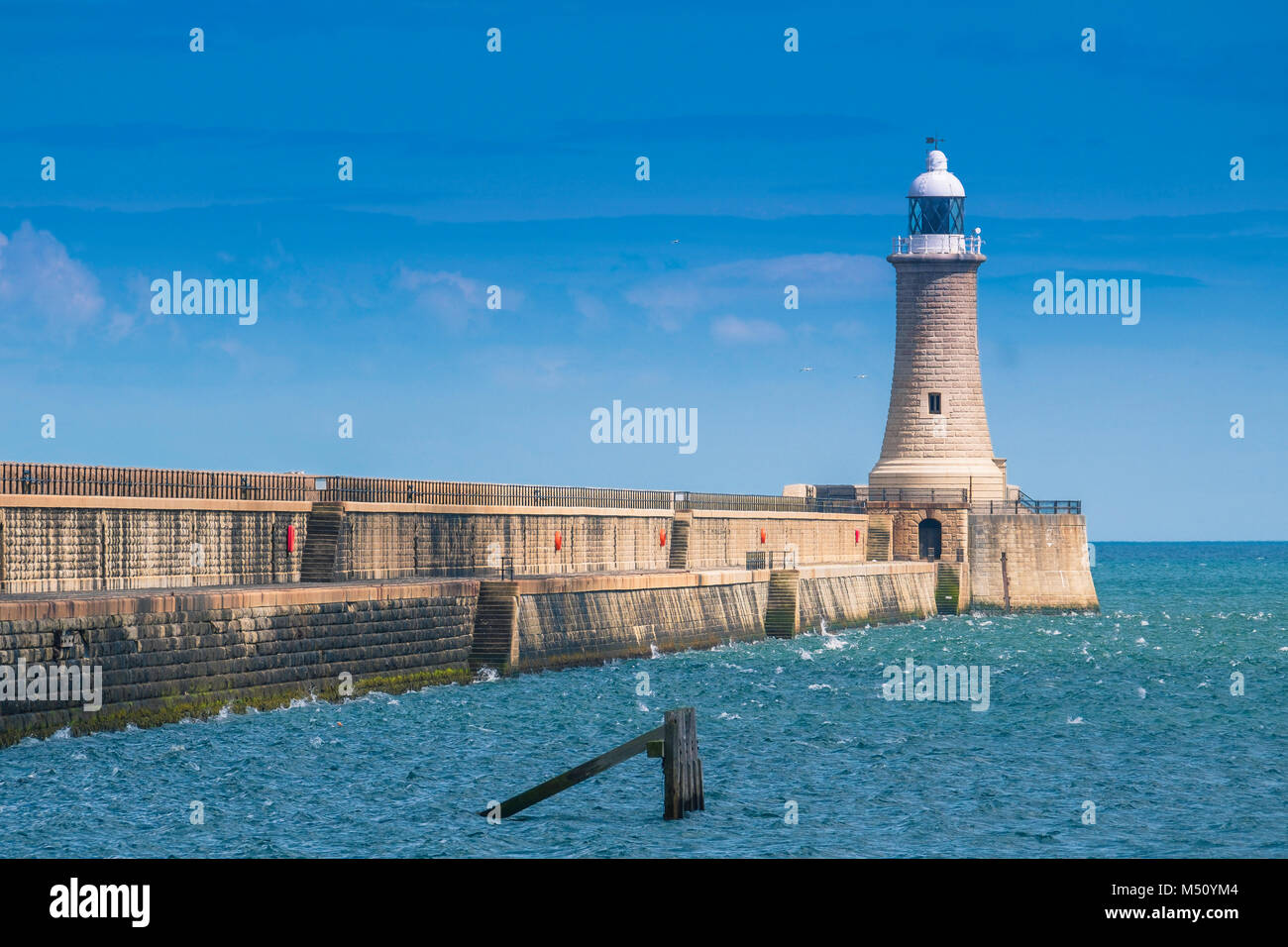 Tynemouth north pier of the harbour and it's lighthouse. Stock Photo