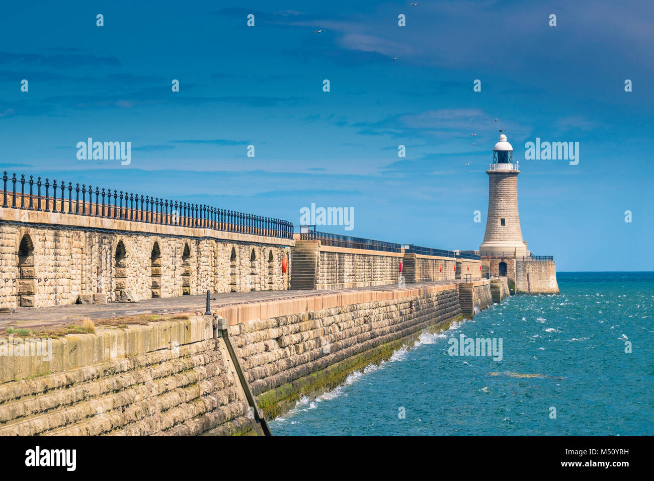 Tynemouth north pier of the harbour and it's lighthouse. Stock Photo