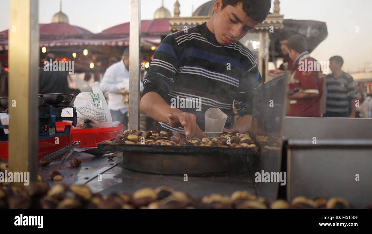 A young roasted chestnut seller on the street in Istanbul Turkey. Stock Photo