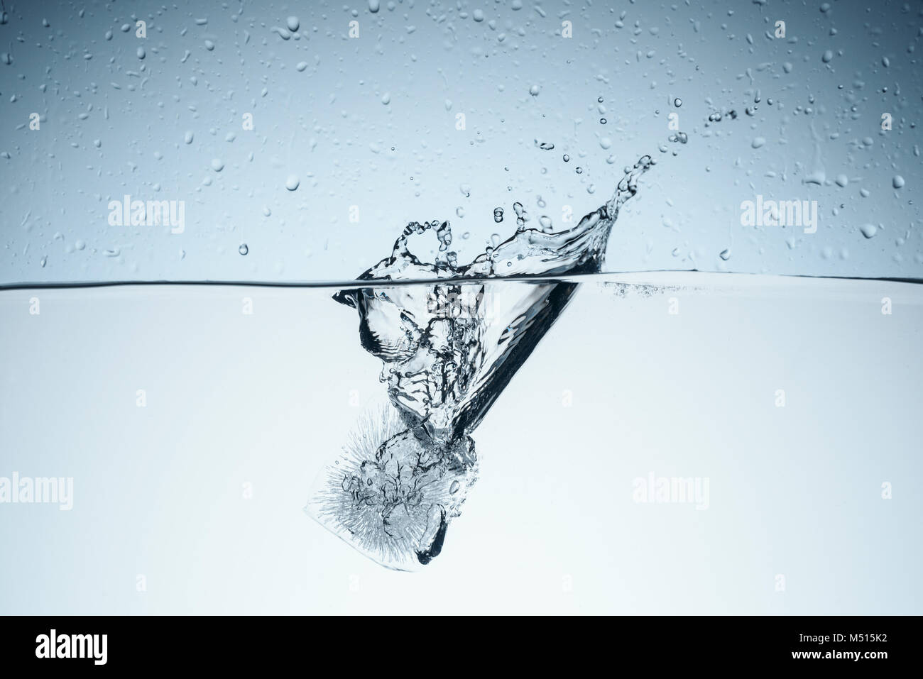 ice cube in water with splash and drops, isolated on white Stock Photo ...