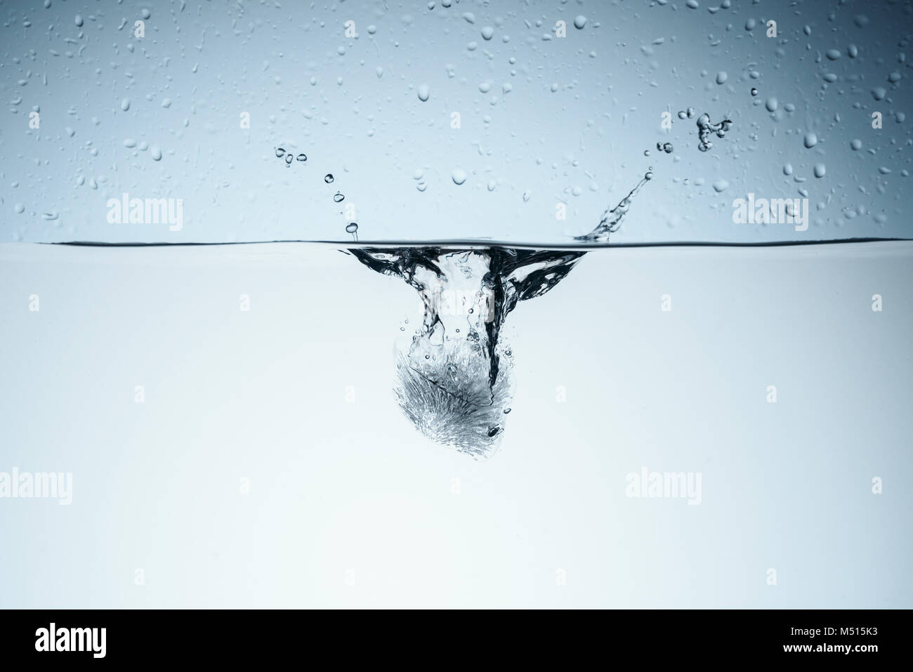 ice cube in water with drops, isolated on white Stock Photo - Alamy