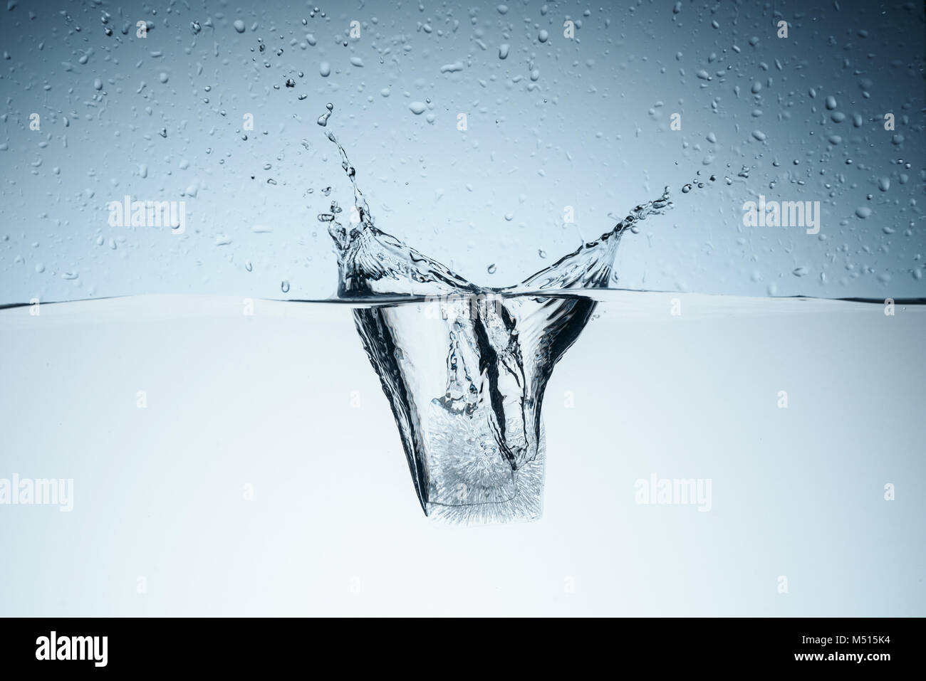 ice cube in water with splash and drops, isolated on white Stock Photo ...