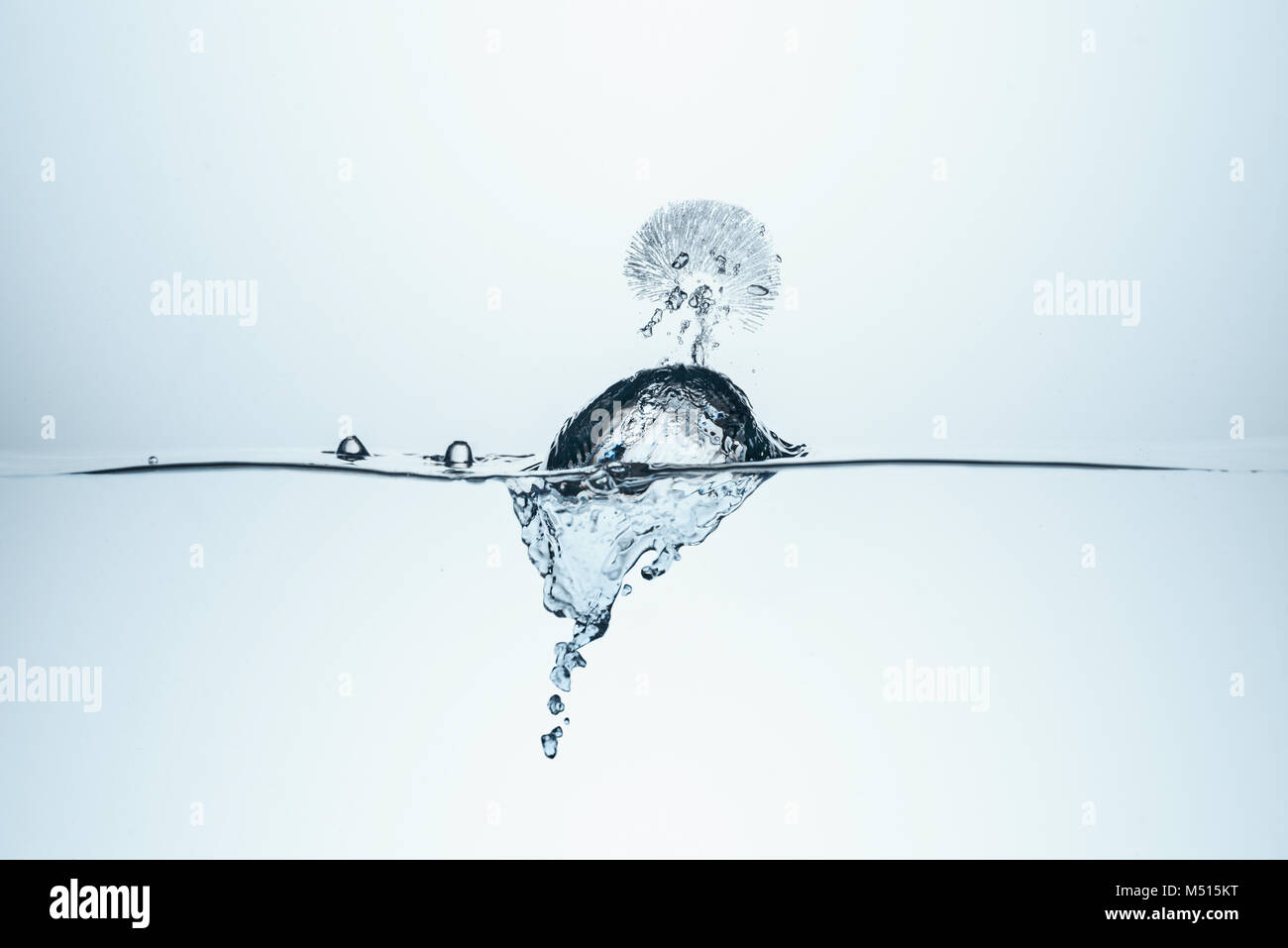 ice cube in water with splash, isolated on white Stock Photo - Alamy