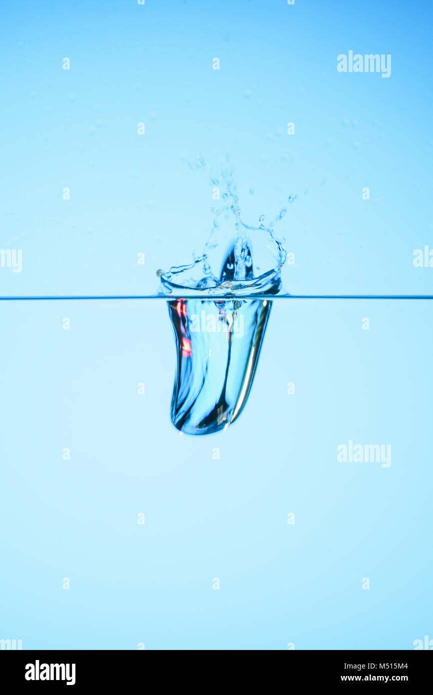 pure water with splash, isolated on blue Stock Photo