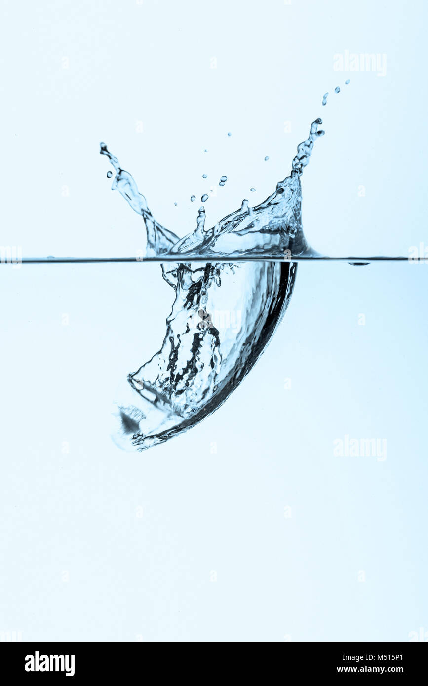 ice cube in water with splash, isolated on white Stock Photo - Alamy