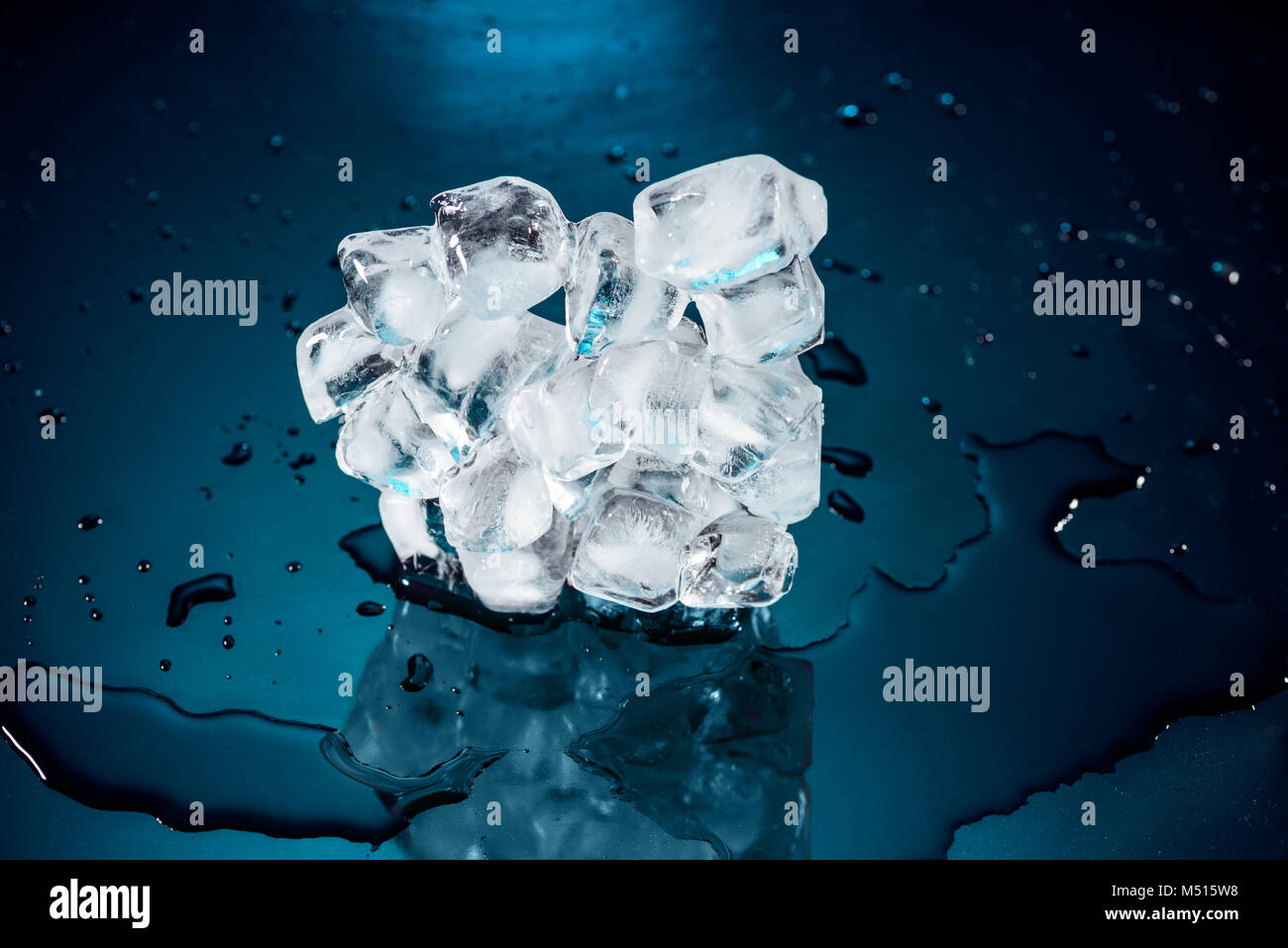 melting ice cubes on black with water and drops Stock Photo - Alamy