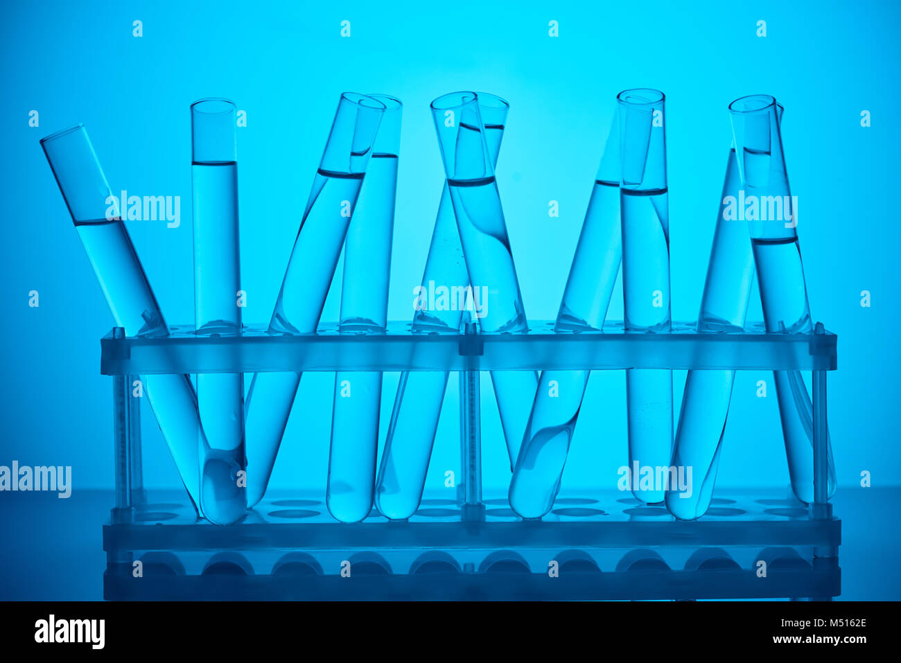 glass tubes with liquid on stand for scientific analysis on blue Stock Photo Alamy