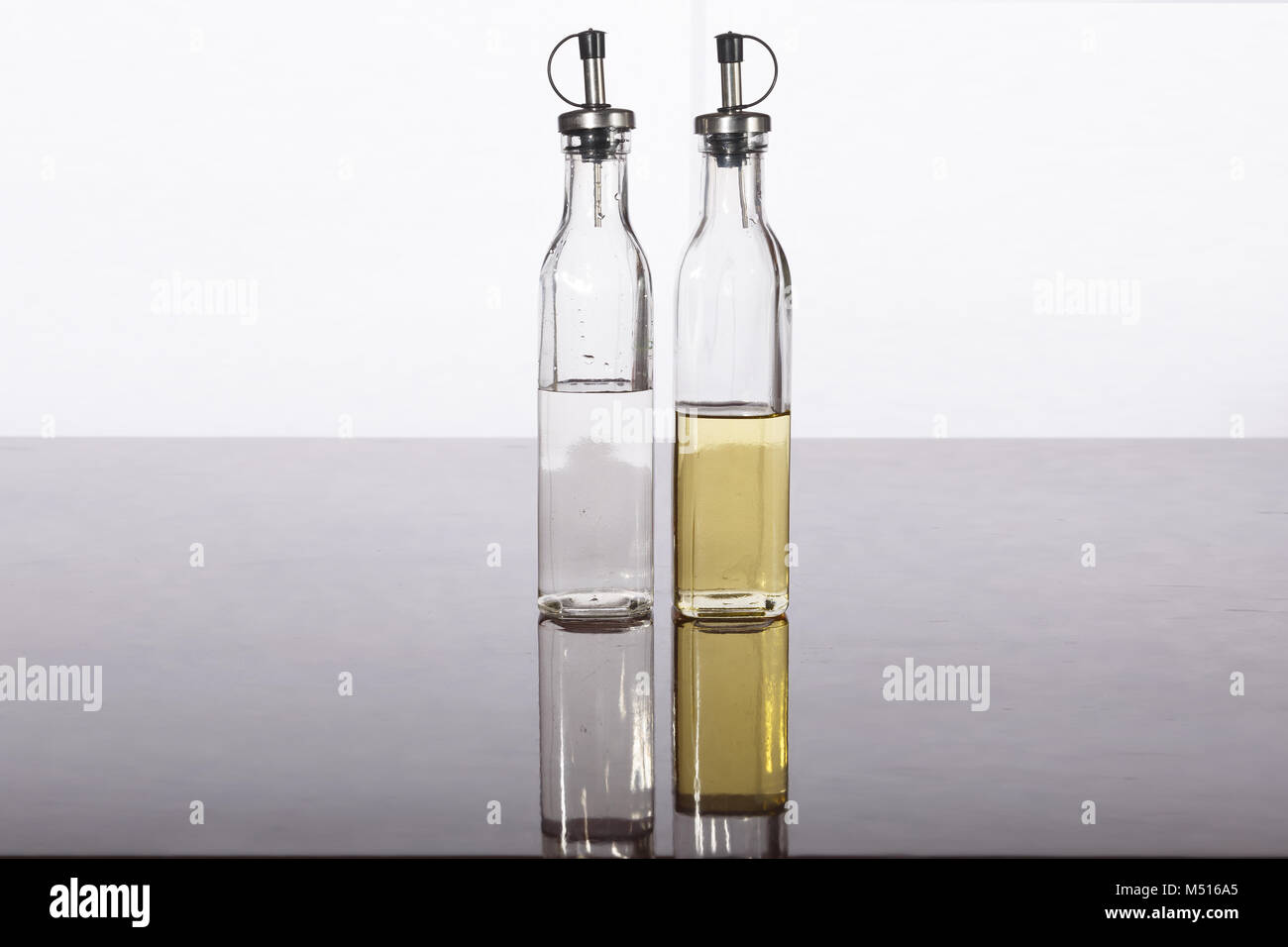 Olive oil and vinegar in bottles on a table Stock Photo