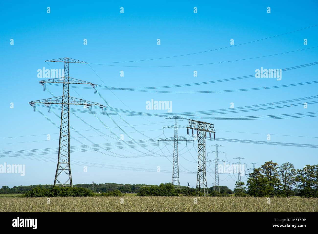 Electric pylons and transmission lines seen in Germany Stock Photo