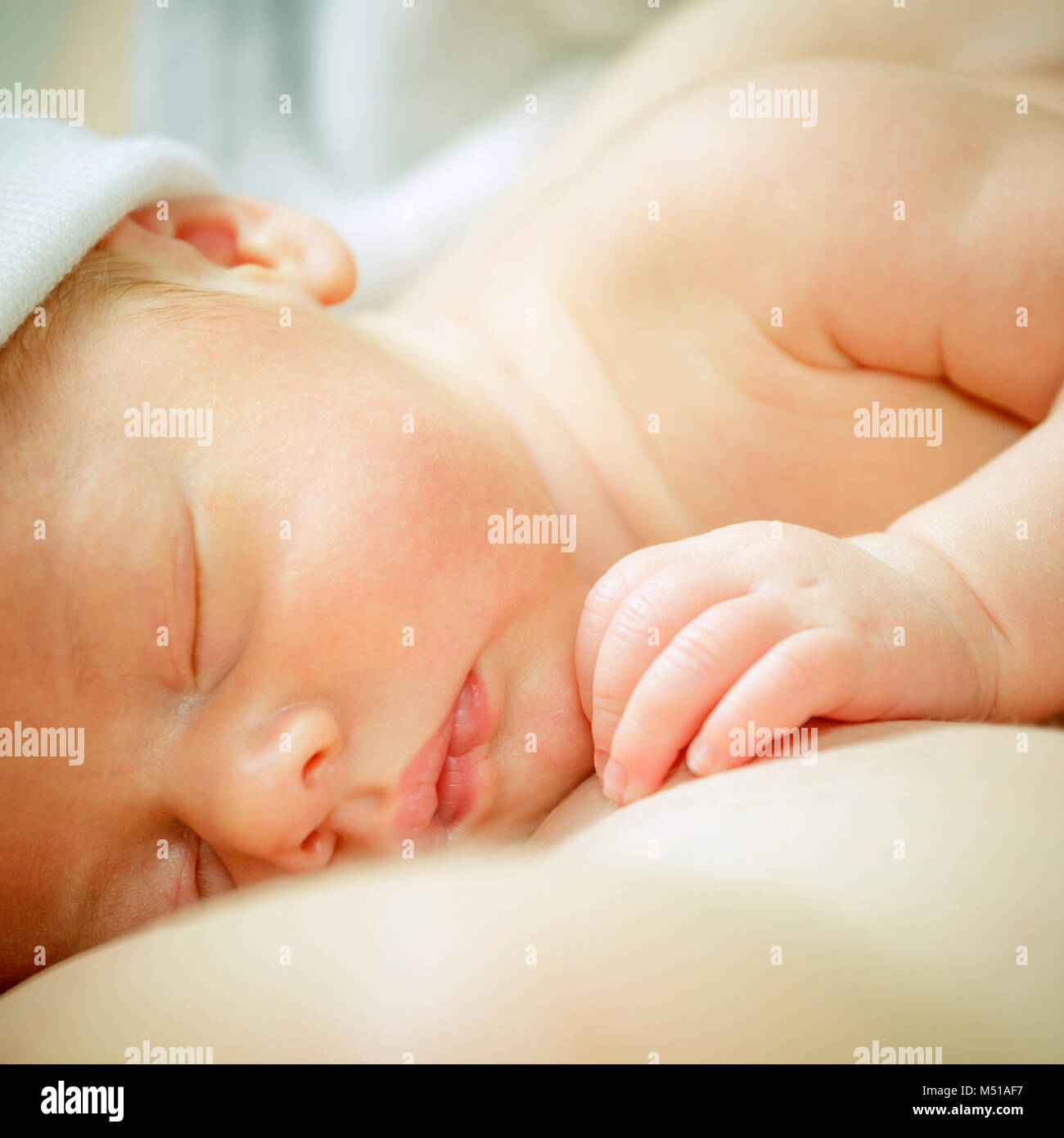 Sleeping baby boy on mother's breast. Newborn baby boy Stock Photo