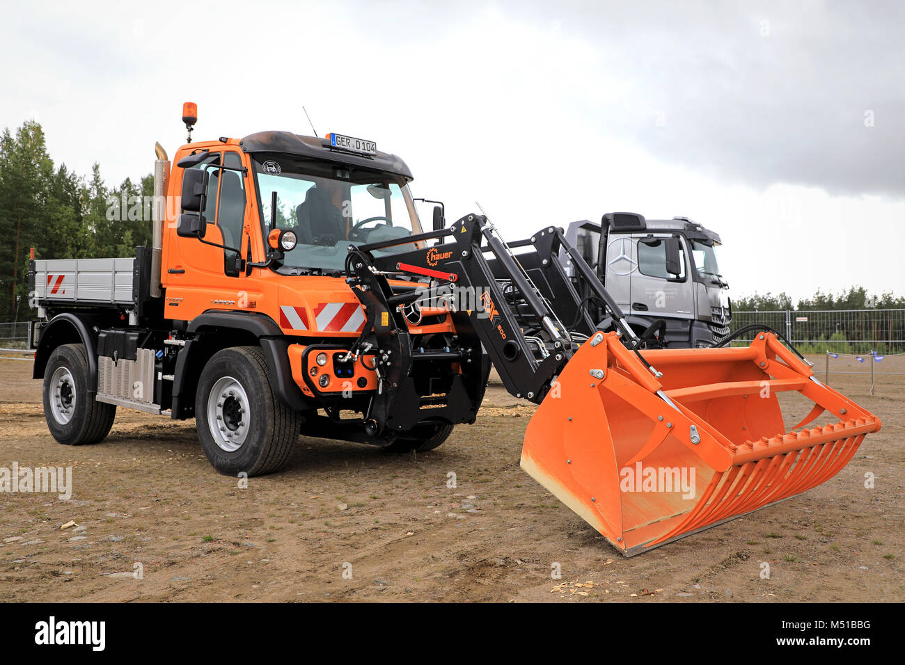 Mercedes-Benz Unimog U423 multi-purpose truck and Hauer RX-500 front loader on Maxpo 2017. Stock Photo