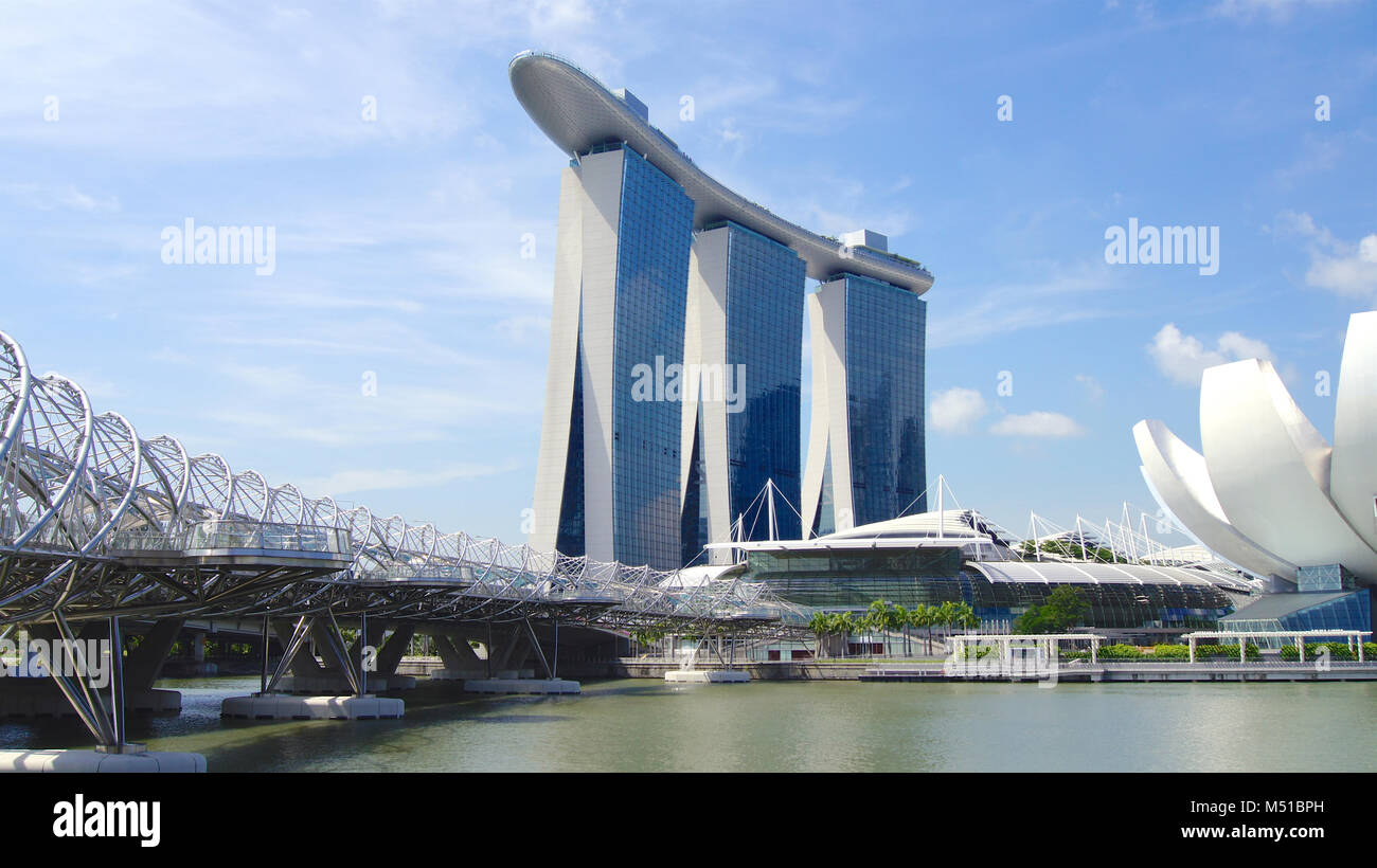 SINGAPORE - APR 1st, 2015: The Marina Bay Sands Resort in Singapore. The roofs of towers are decorated with a park in the form of a ship 340 m long and capacity up to 3,900 people Stock Photo