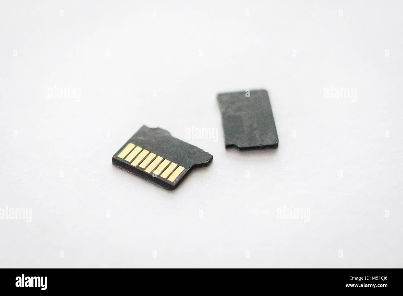 Broken destroyed micro sd card on white surface close Stock Photo - Alamy