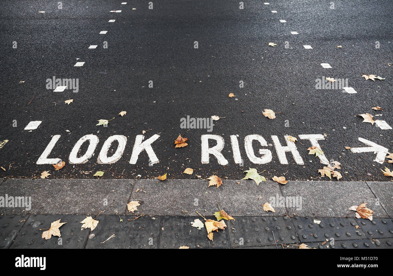Look right. Caution road marking for pedestrians shows direction of approaching traffic in London city Stock Photo
