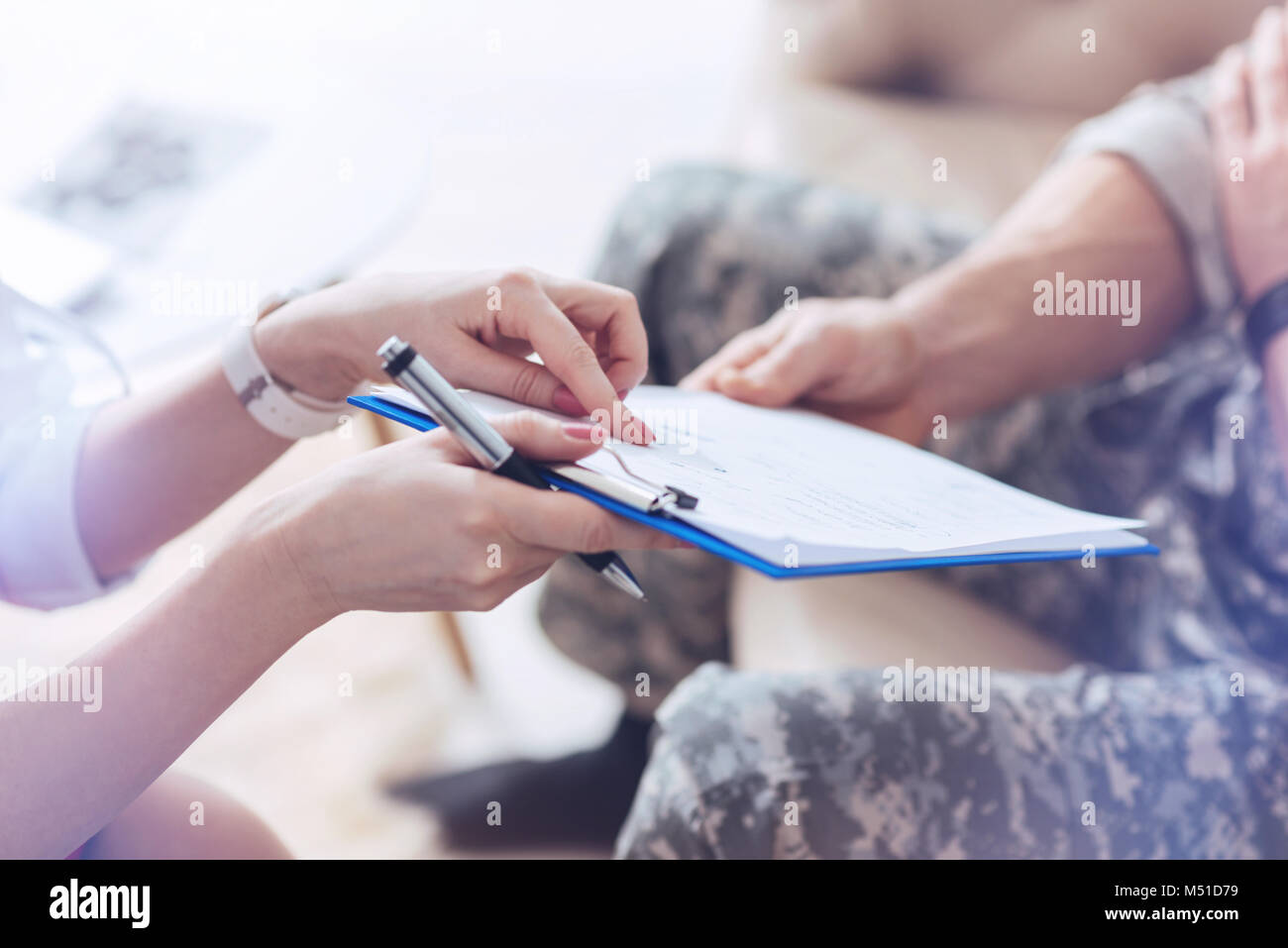 Scale up look on therapist showing test results to patient Stock Photo
