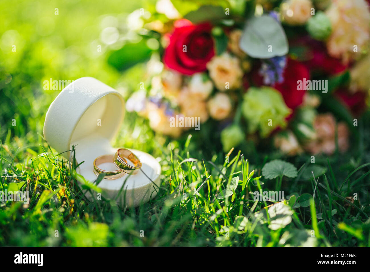 Wedding rings on in grass hi-res stock photography and images - Alamy