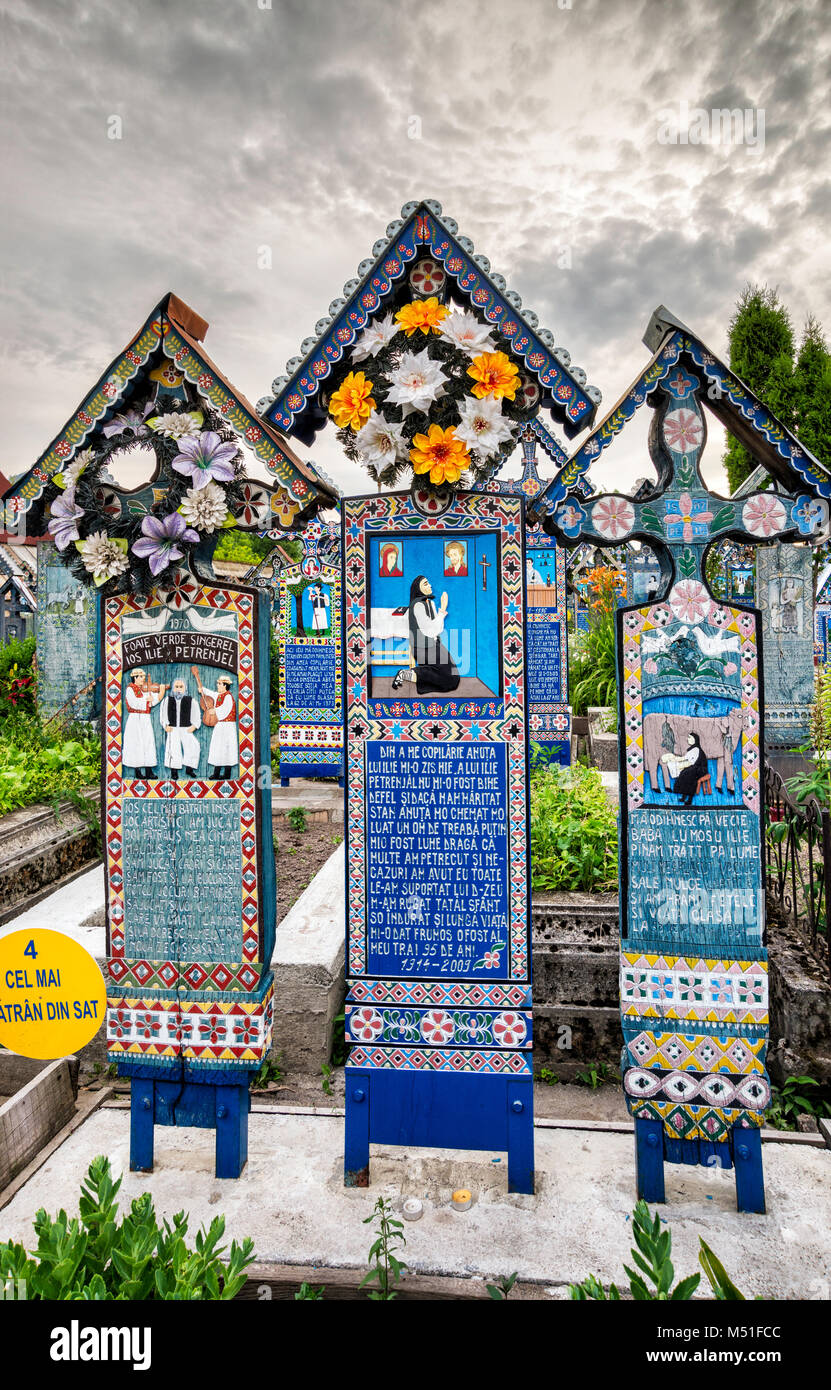 Carved wooden panels with epitaphs at crosses on graves, Merry Cemetery (Cimitirul Vesel) in Sapanta, Maramures Region, Romania Stock Photo