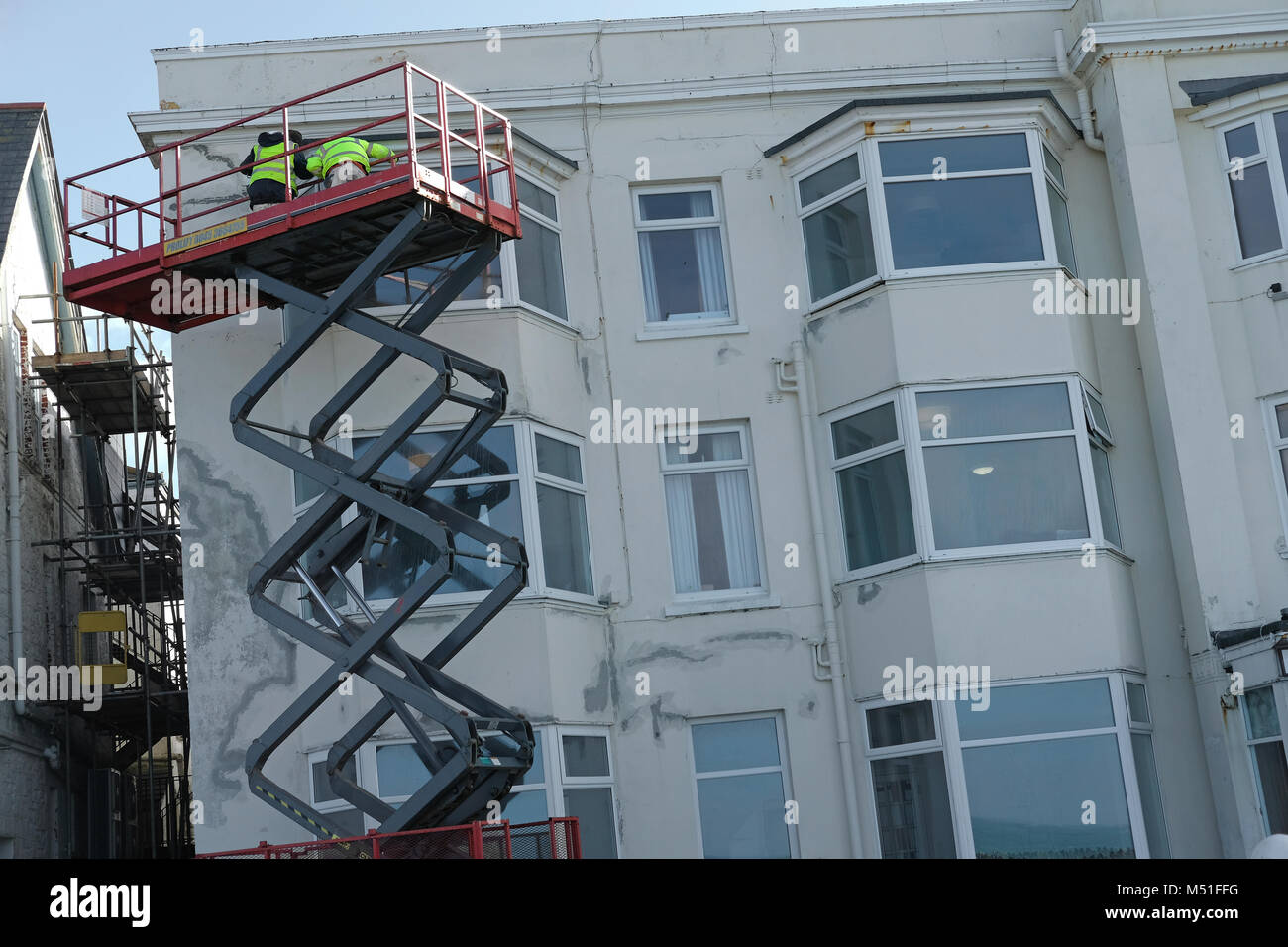 Two men working on a block of flats. Stock Photo