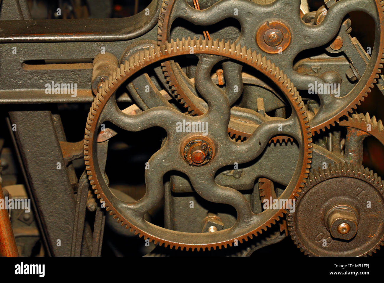 Old cogs on a piece of heavy industrial machinery Stock Photo