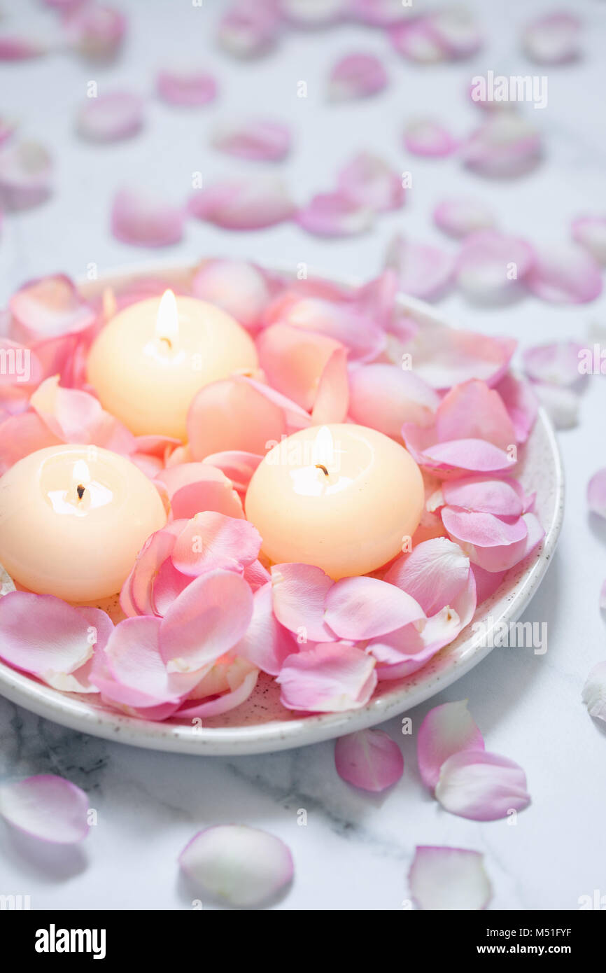 Pink roses and candles Stock Photo - Alamy