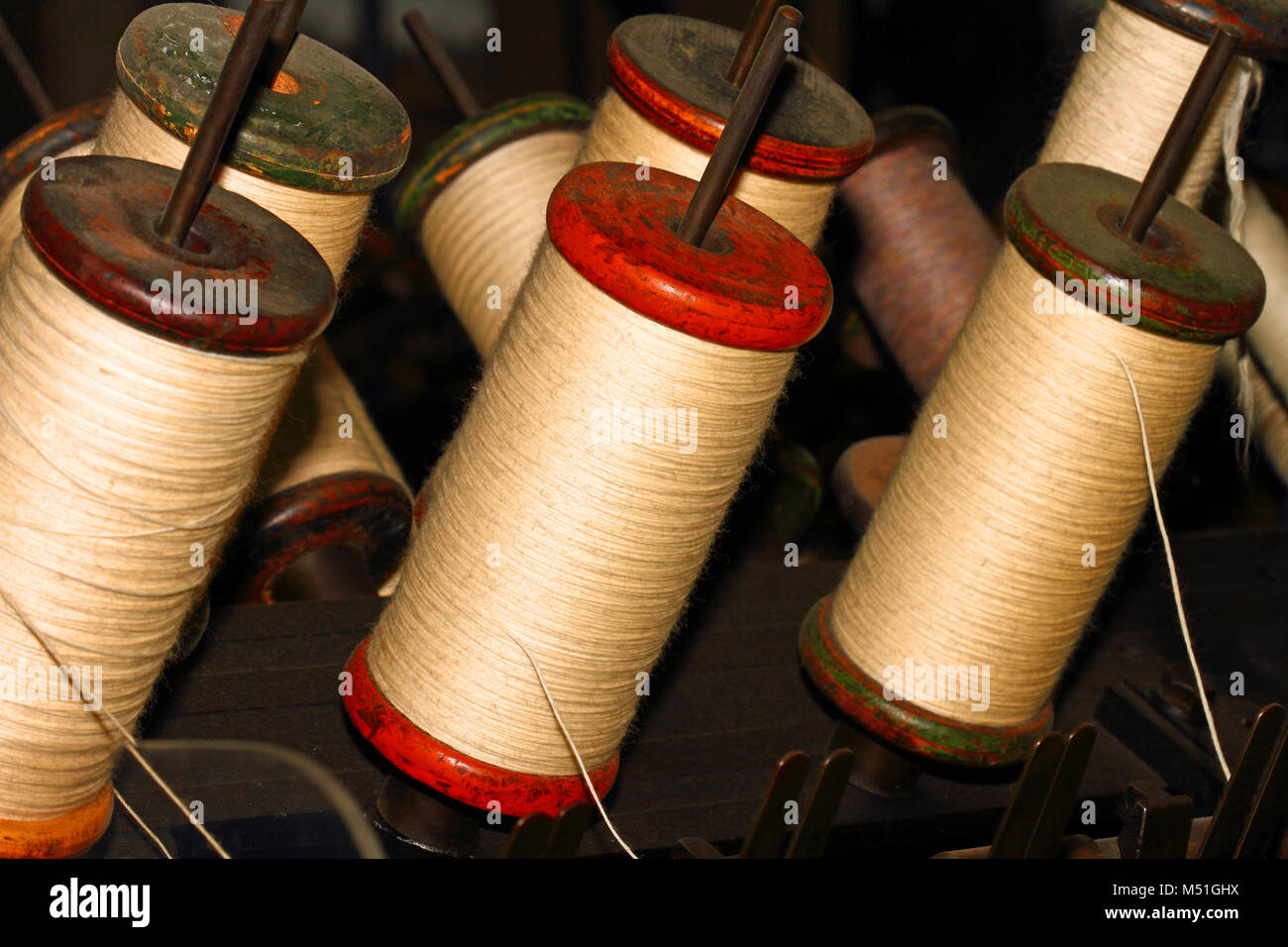 Woollen thread on a spool or bobbin Stock Photo - Alamy