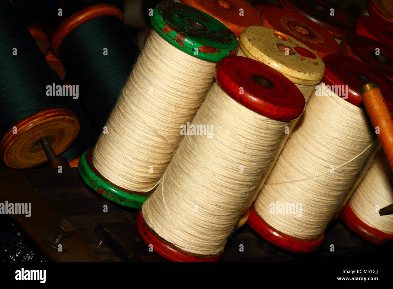Woollen thread on a spool or bobbin Stock Photo - Alamy