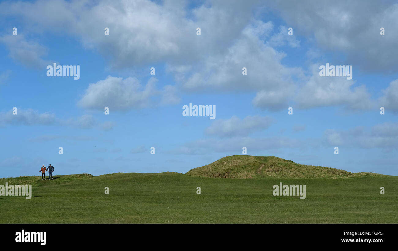 Two people walking outside Newquay, Cornwall. Stock Photo