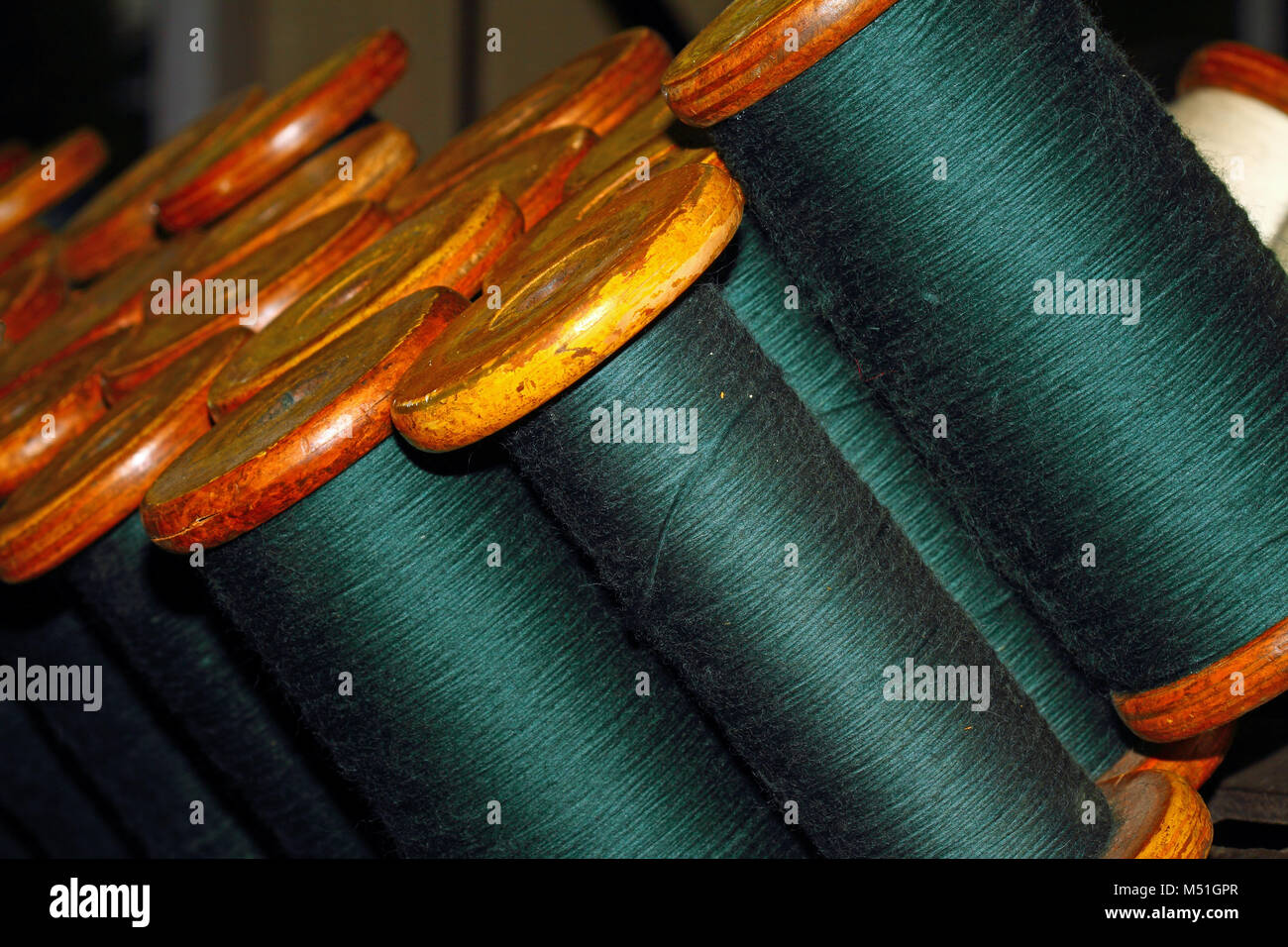 Woollen thread on a spool or bobbin Stock Photo - Alamy