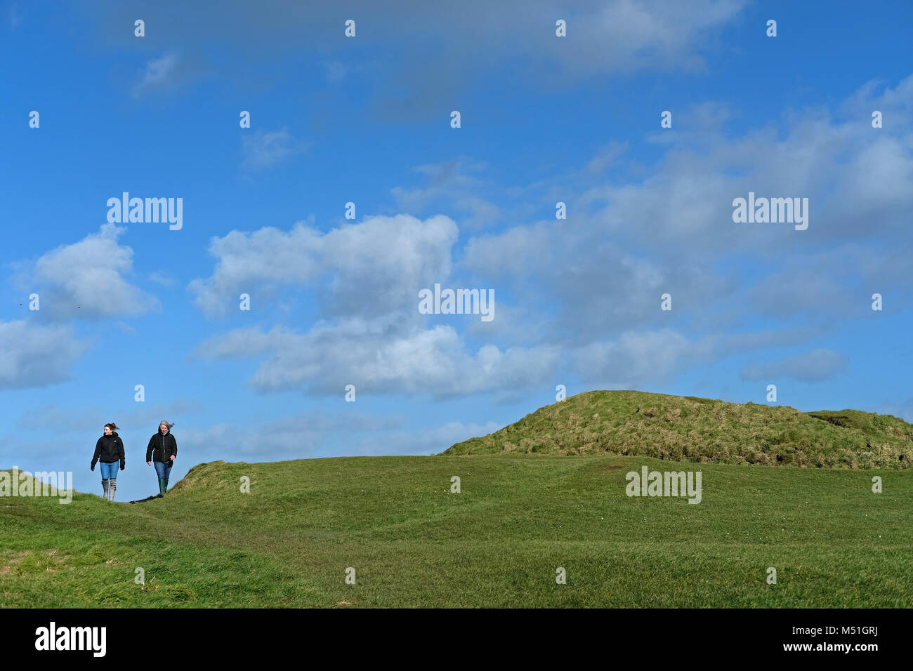 Two people walking outside Newquay, Cornwall. Stock Photo