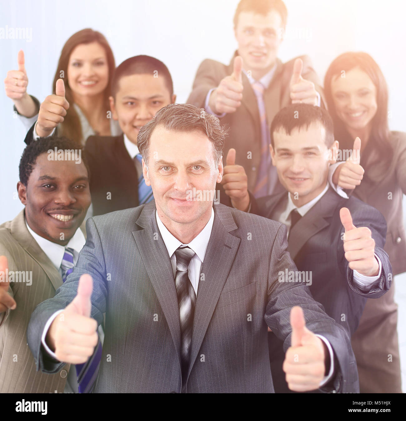 happy business team holding thumbs up Stock Photo - Alamy
