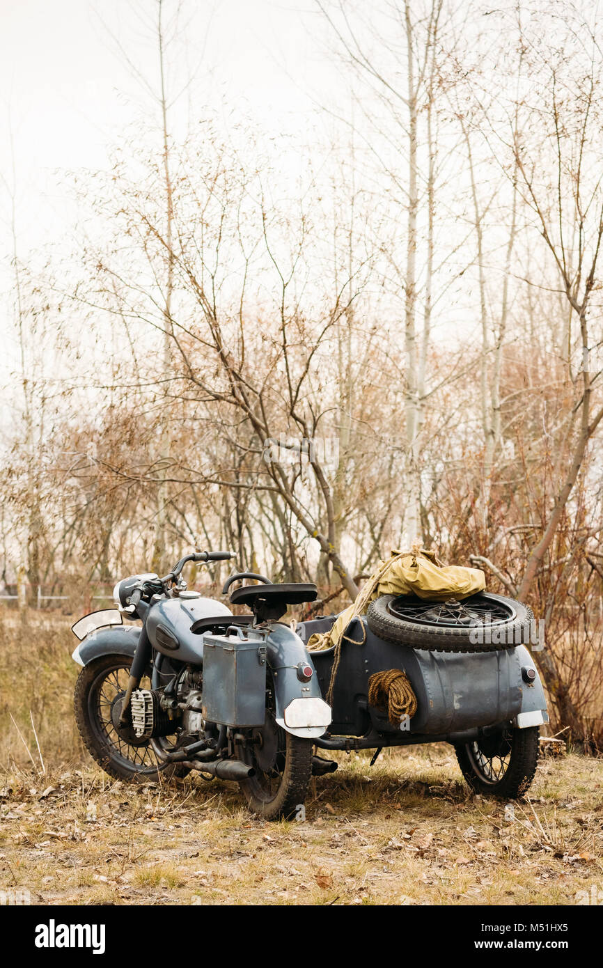 Vintage military motorcycle standing in a field during the reconstruction of Liberation of Gomel Stock Photo