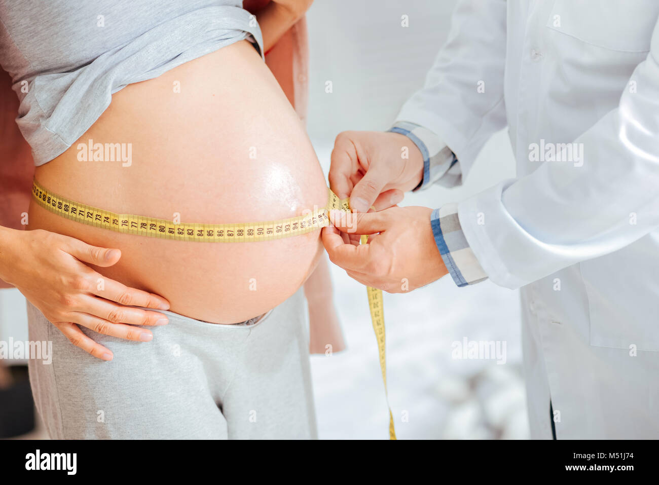 Close up of pediatrician measuring baby bump Stock Photo Alamy