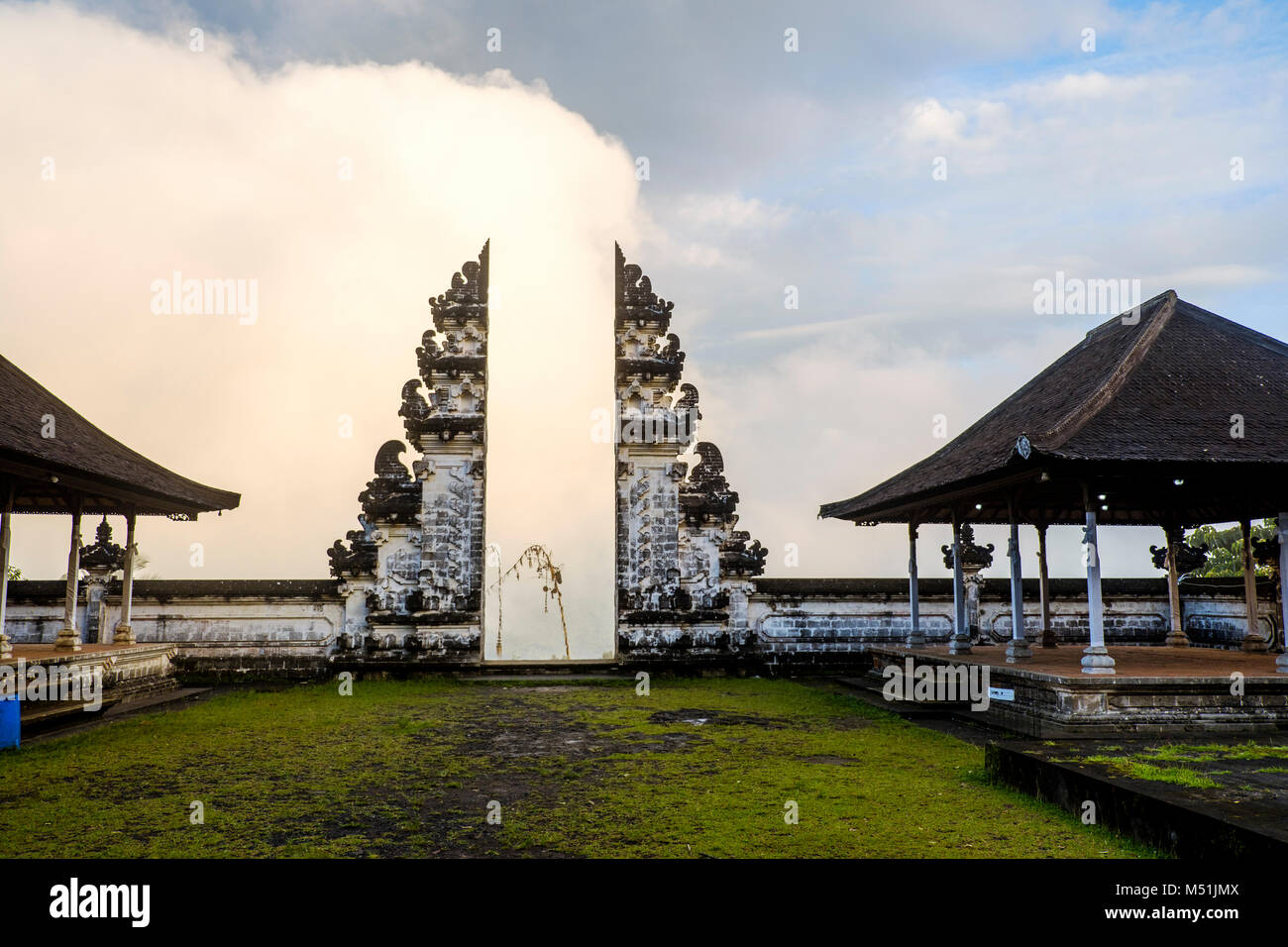 Clouds hinder the view through the split gateway ('candi bentar') of the outer sanctum, Pura Lempuyang temple, Bali, Indonesia. Stock Photo