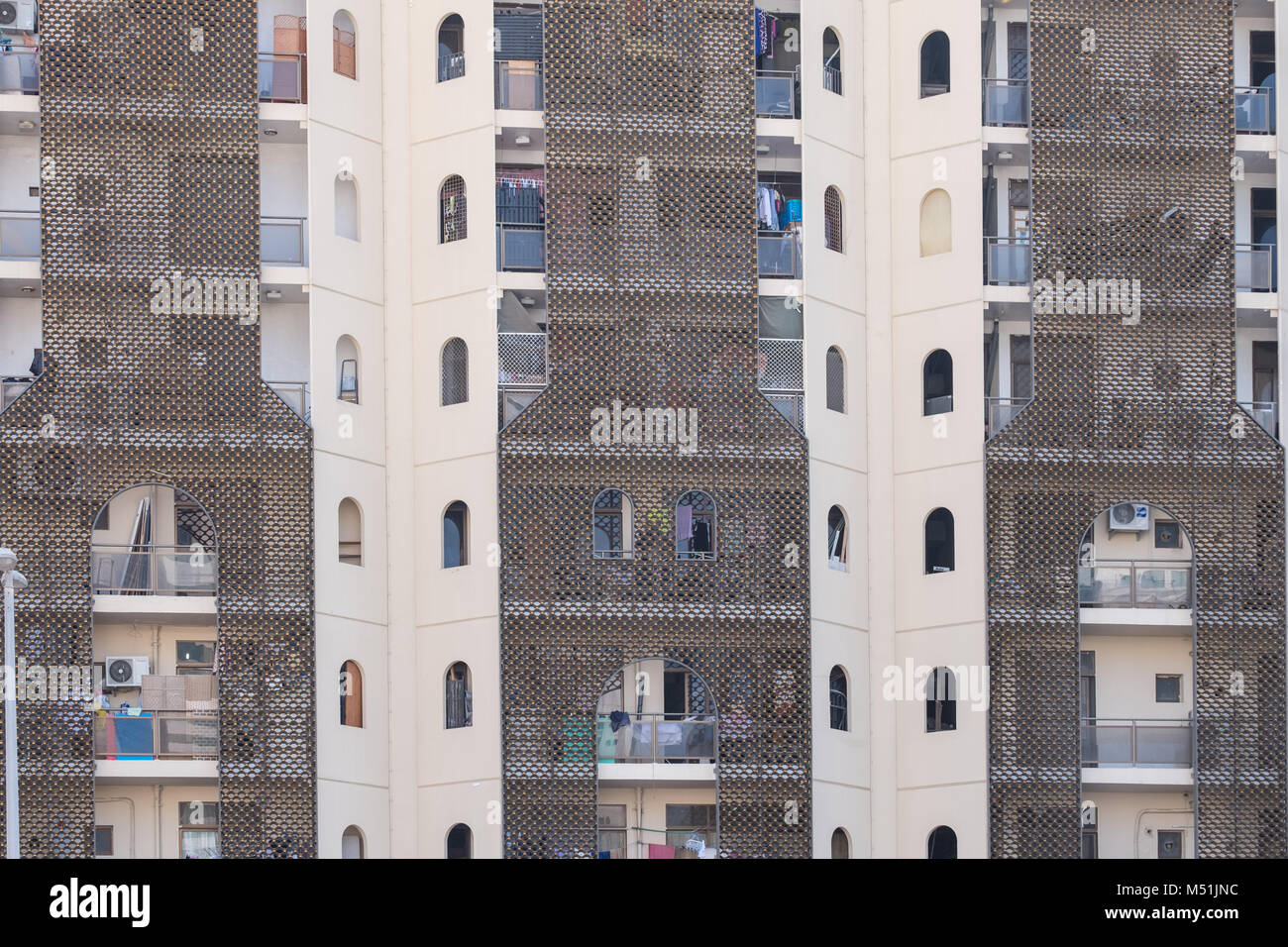 Facade of a tall busy residential building Stock Photo