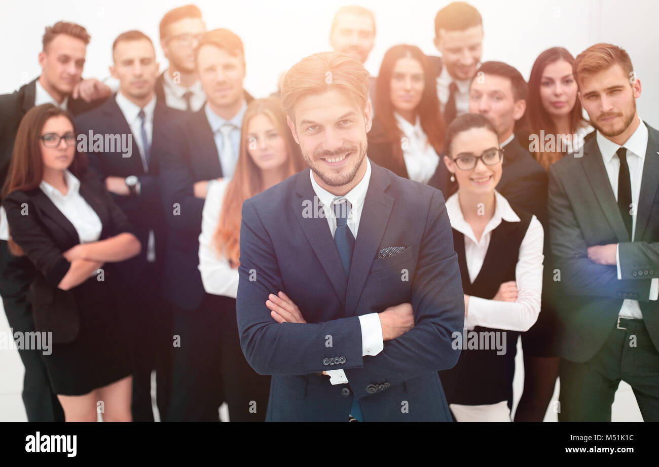 smiling businessman standing on background of her business team Stock ...