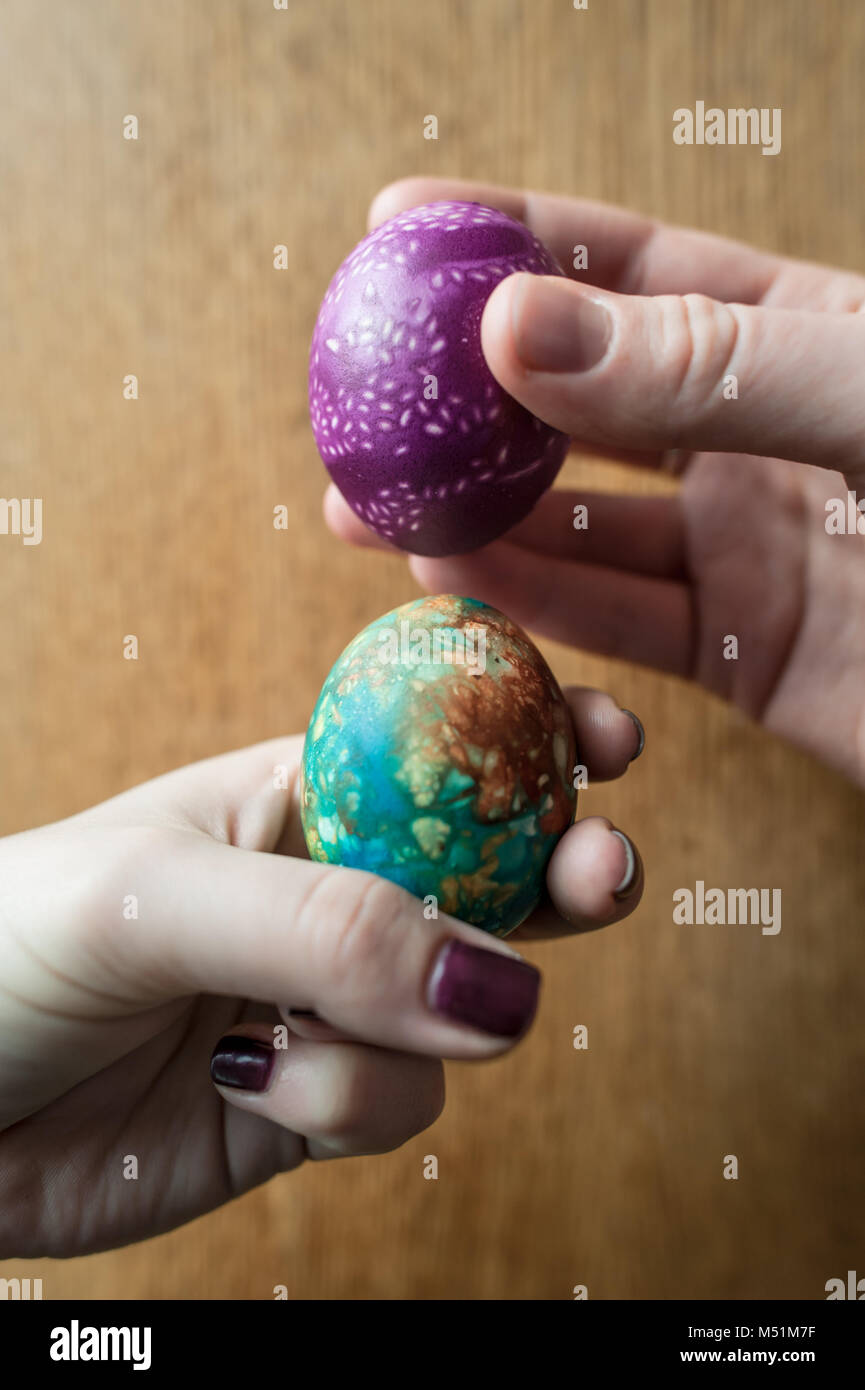 Two hard boiled and decorated easter eggs are knocked together in a traditional game Stock Photo