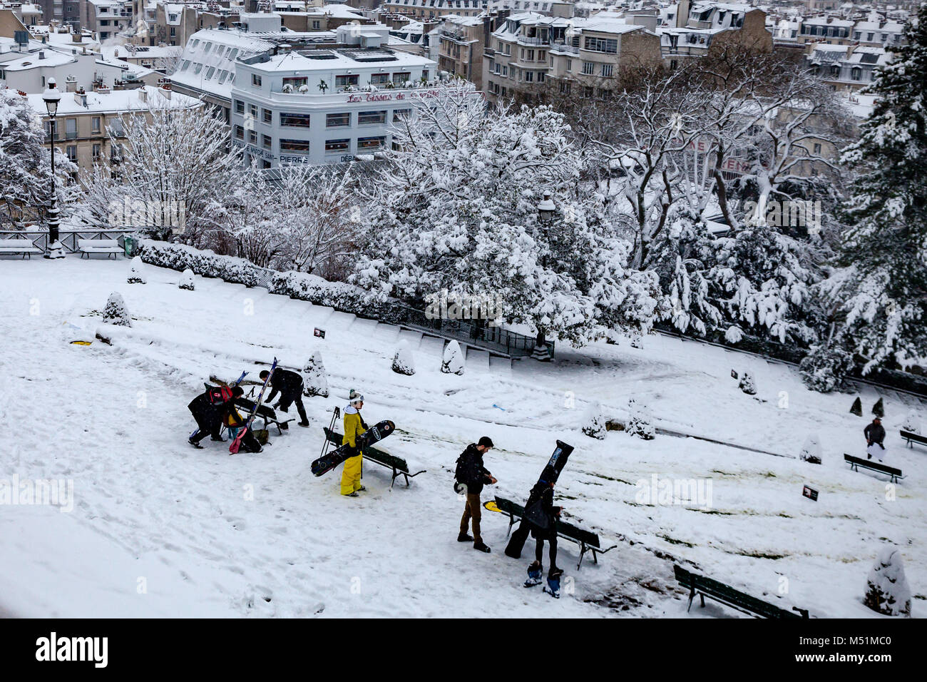 People skiing and enjoying the snow in Louise Michel square in Paris, Montmartre, France Stock
