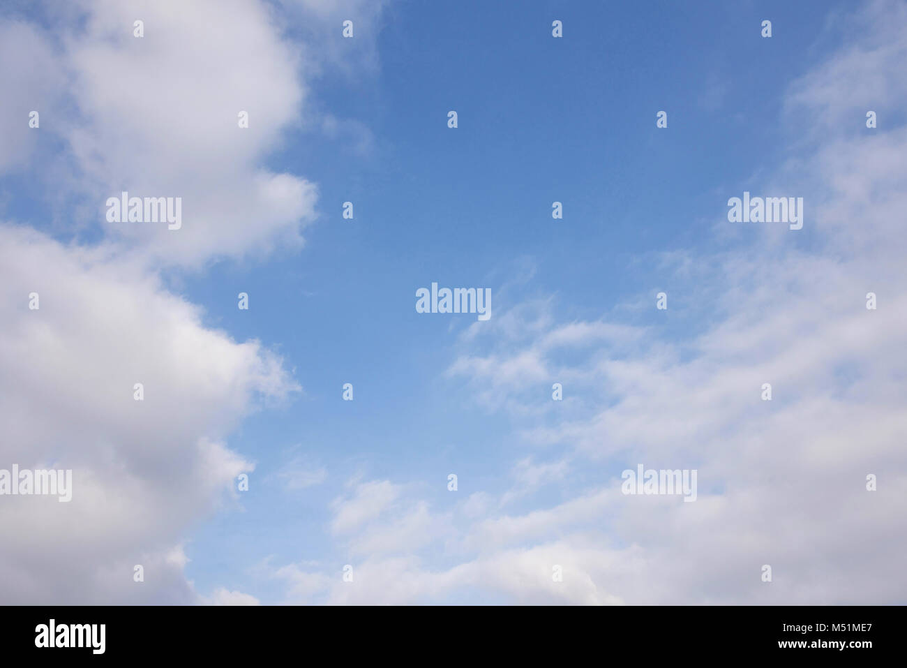 Blue sky with white fluffy clouds Stock Photo - Alamy